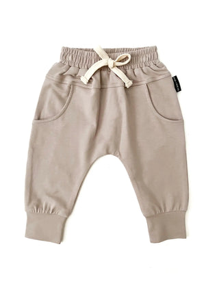 A pair of sand-colored organic bamboo joggers for babies and toddlers.